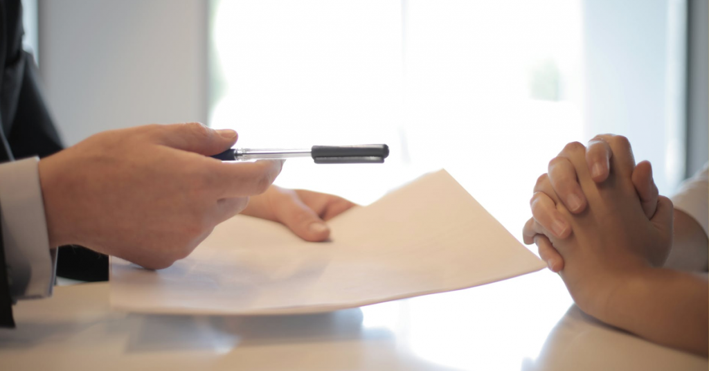 crop-businessman-giving-contract-to-woman-to-sign